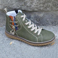 Olive green high-top ankle boot with lace-up closure, plush lining, and textured outsole