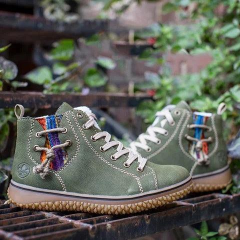 Pair of green high-top ankle boots with lace-up fronts, plush lining, and textured soles