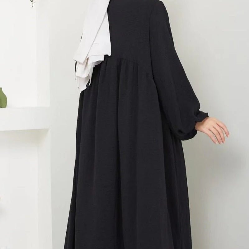Black pullover abaya with pleated bodice and flared lantern-style sleeves