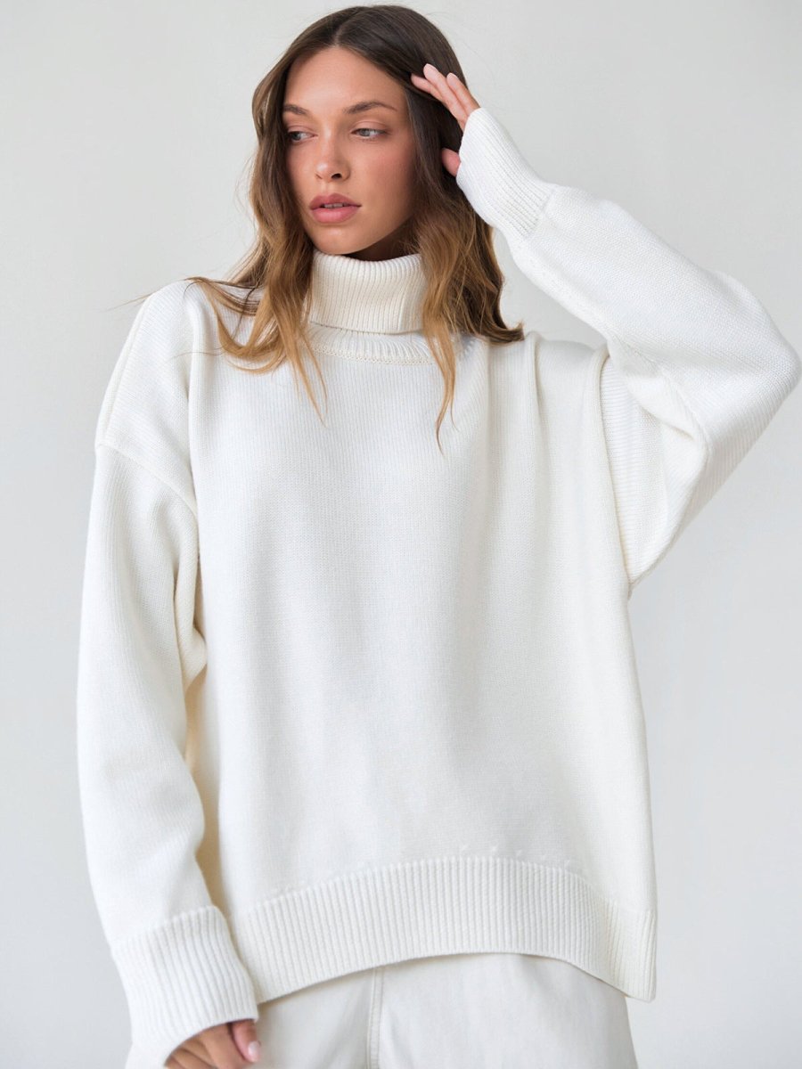White turtleneck pullover sweater with ribbed collar, cuffs, and hem
