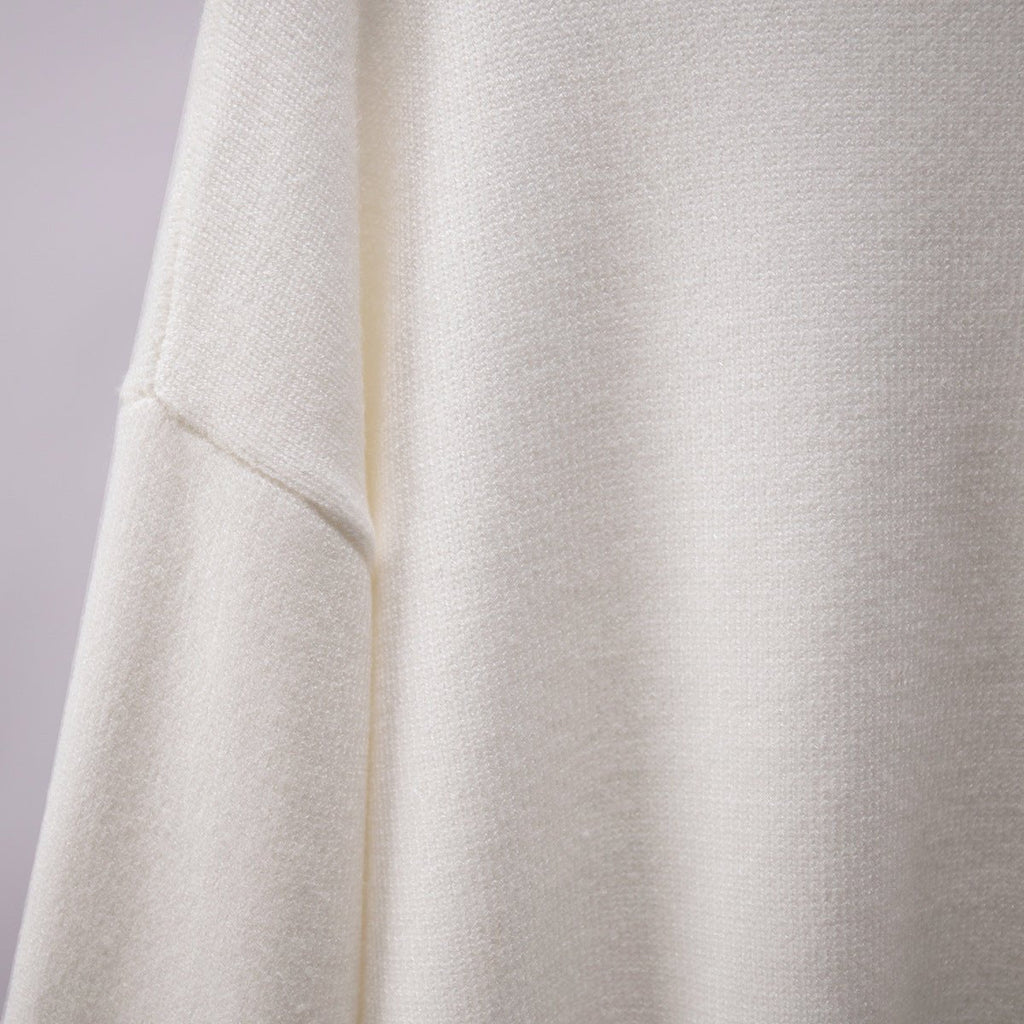 White knit turtleneck pullover sweater close-up of sleeve seam