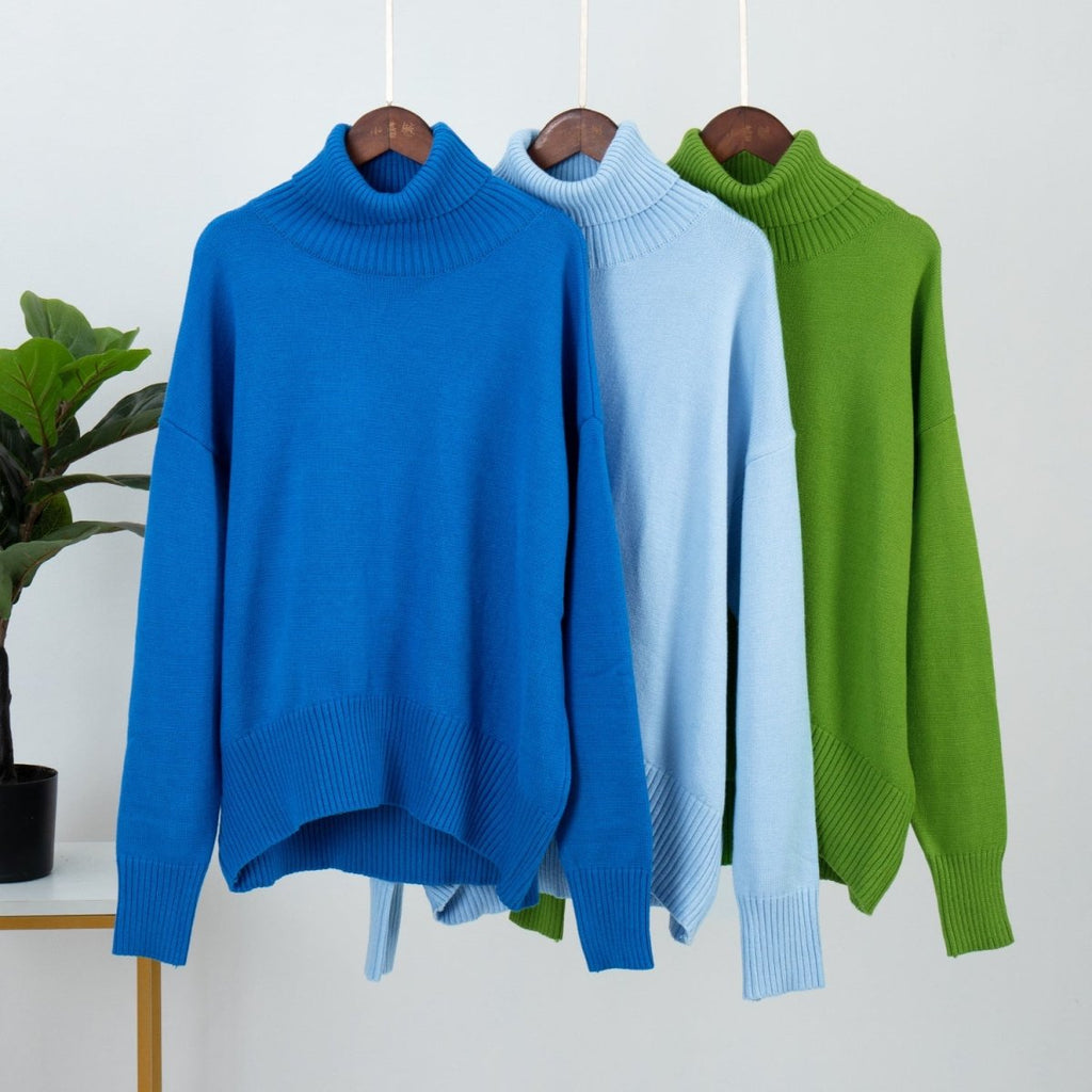 Blue turtleneck pullover sweater on hanger with ribbed collar and cuffs