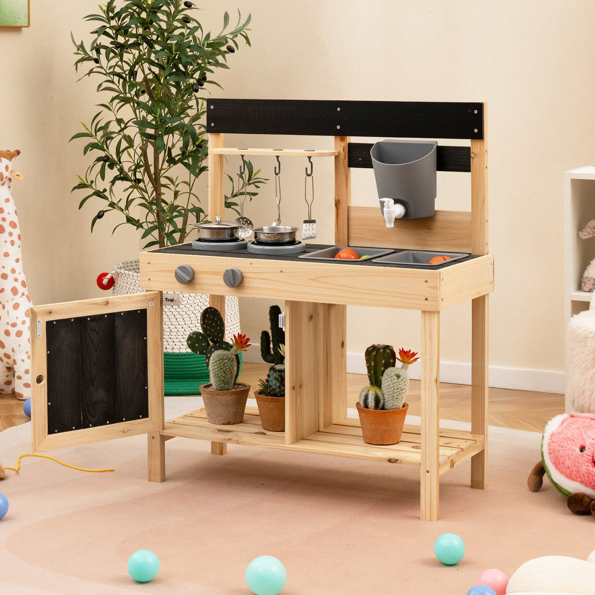 Kids wooden outdoor play kitchen with black countertop, two burners, and removable sinks