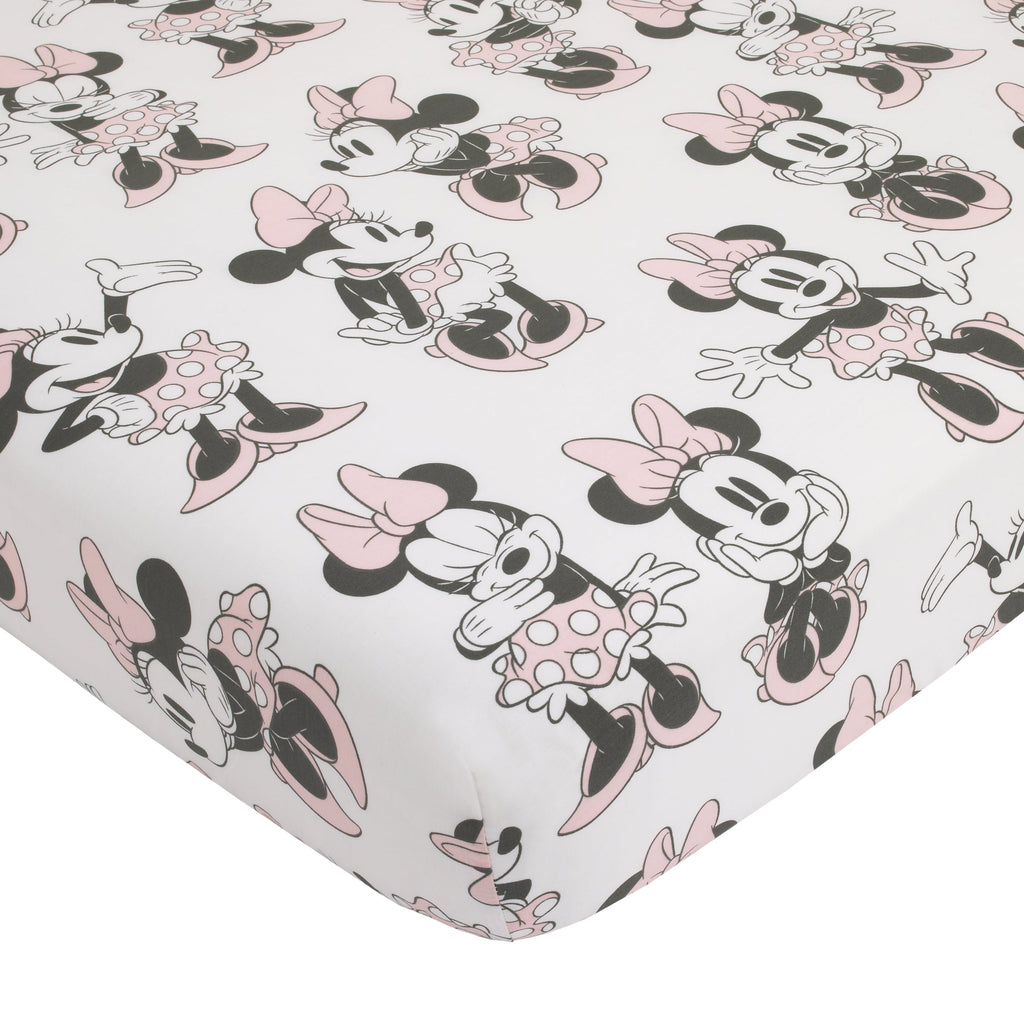 Crib fitted sheet with Minnie Mouse character pattern in pink, grey, and white