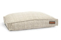 Pet lounger bed with beige-and-white grid fabric, rectangular cushion with side label