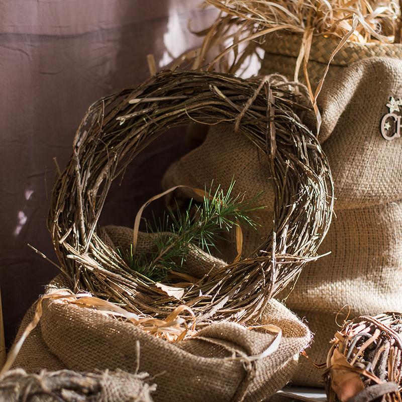Dark twig wreath ring with pine sprig accents and burlap scarf ties