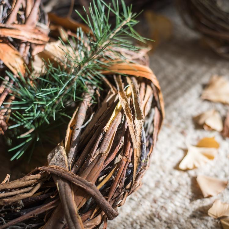Natural twig wreath with green pine sprigs and textured branch weave