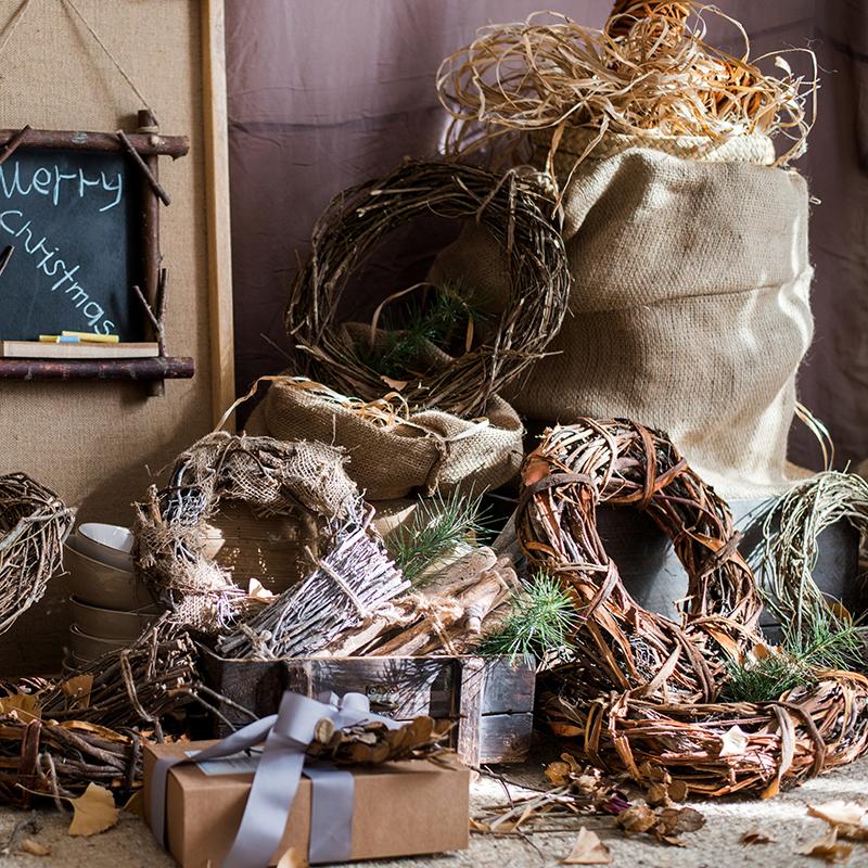 Natural wreath with dark twig ring and pine sprigs, styled for fall holiday decor