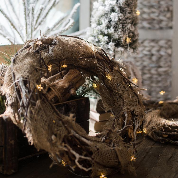 Natural burlap twig wreath with warm string lights and pine greenery