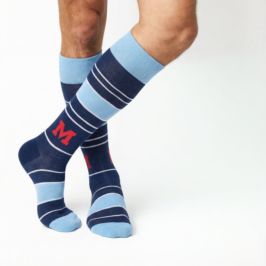 Crew dress socks in navy and light blue stripes with red M logo on wearer