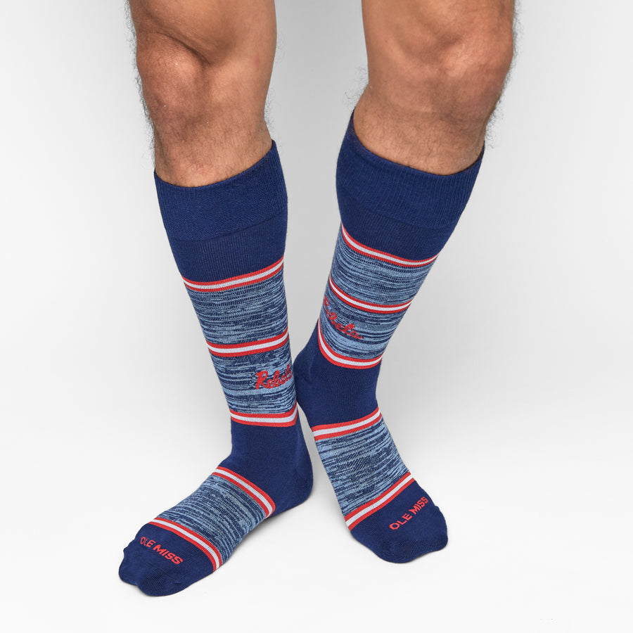 Pair of navy crew socks with red-and-white stripe bands and knit texture