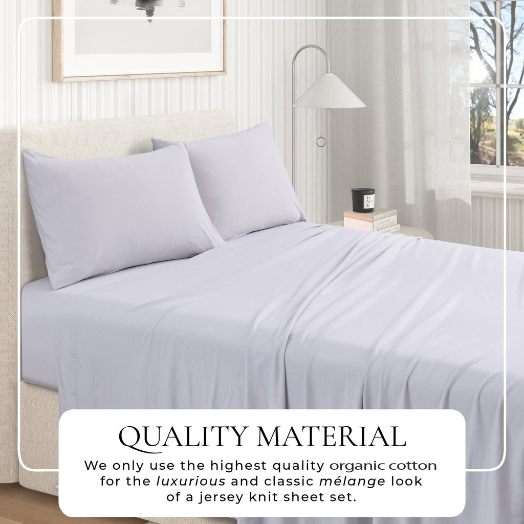 Jersey knit sheet set on bed with pillows, light grey