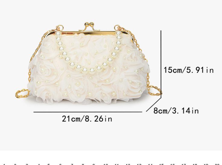 White pleated lace clutch with pearl bead details and gold kiss-lock frame