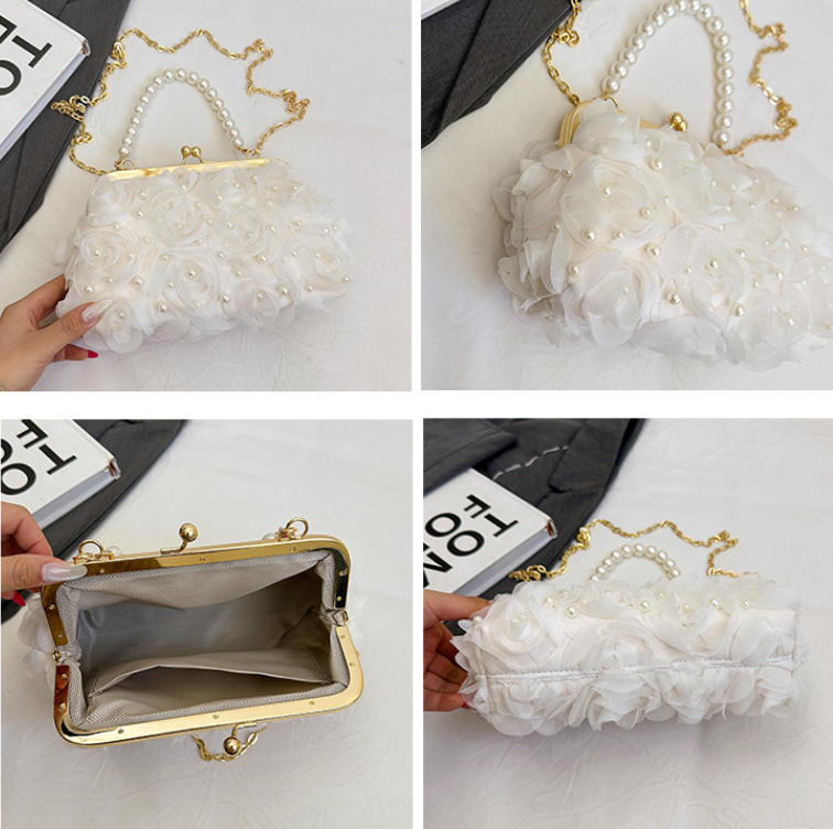 Open white lace pleated clutch with gold clasp, faux pearl trim, and shoulder chain