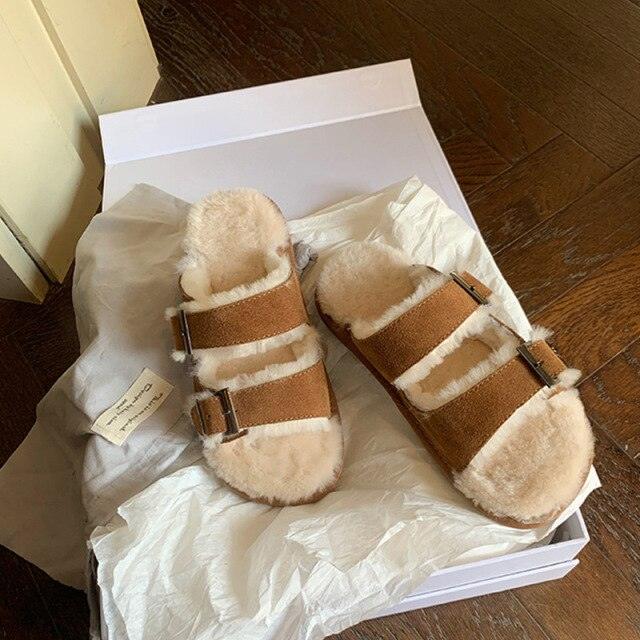 Brown double-buckle faux-fur slippers in a white box, indoor house shoe style