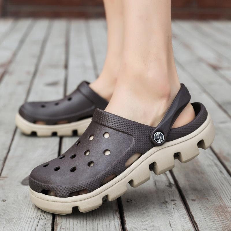 Gray-brown perforated slip-on clogs with adjustable back strap and beige sole