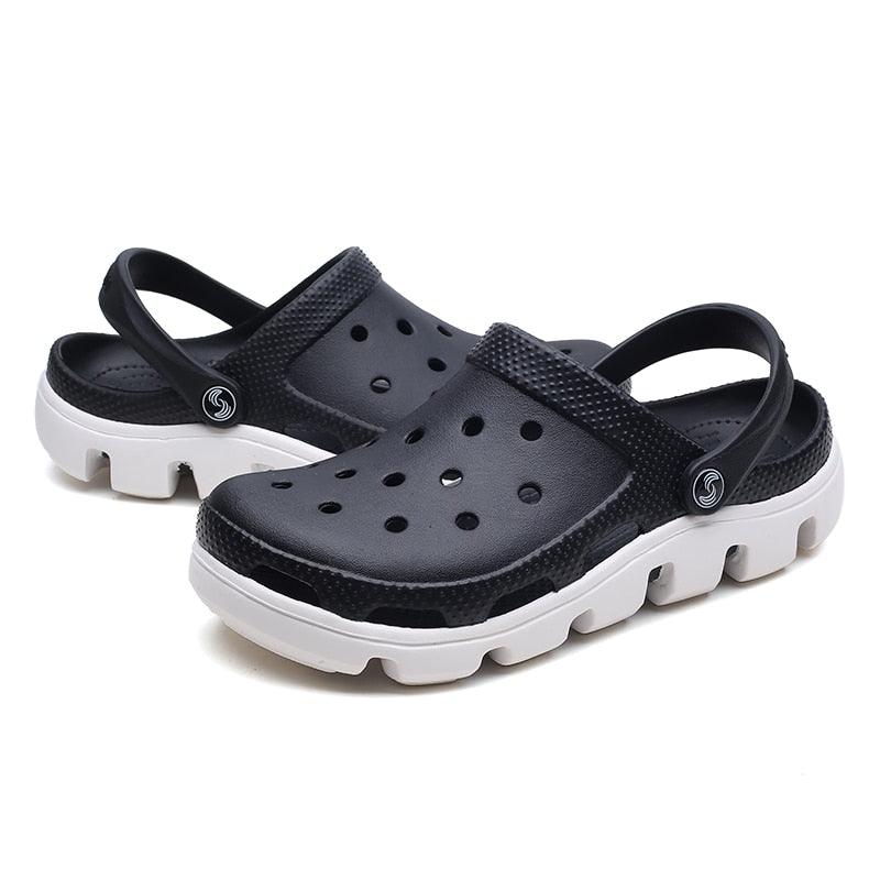Men's slip-on garden clog sandals, black pair with perforated upper and white outsole