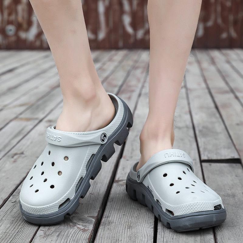 White perforated clogs with gray back strap and dark outsole for everyday wear
