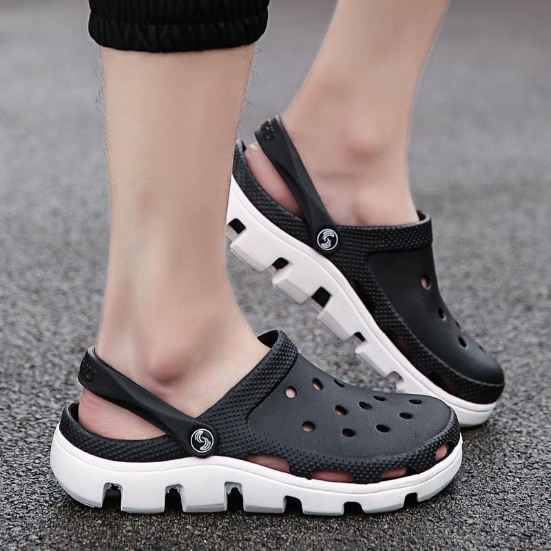 Men's black perforated jelly clogs with adjustable strap and white tread accents