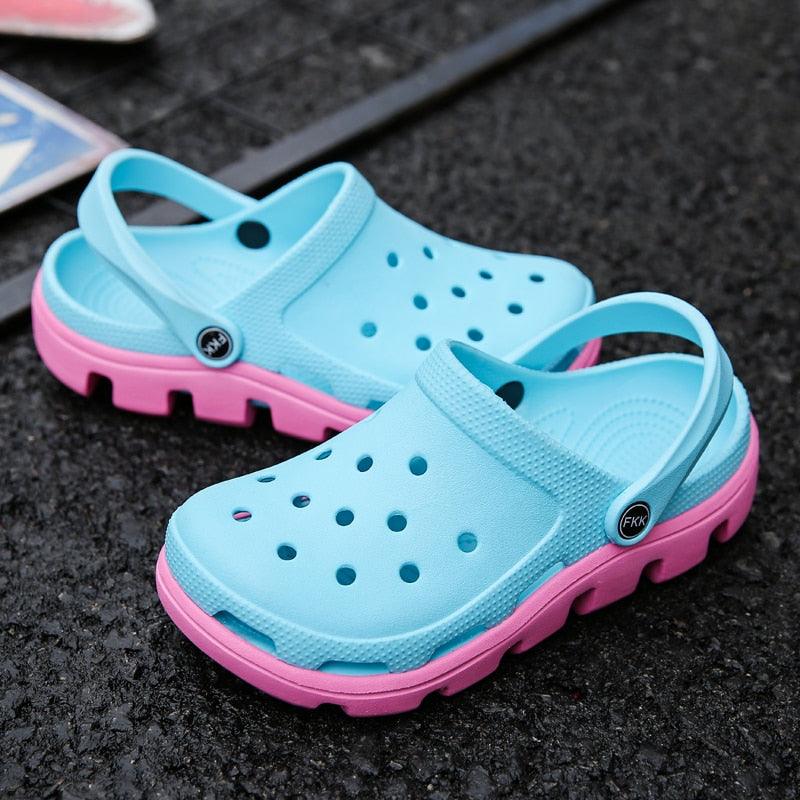 Light blue jelly clogs with pink outsole, perforated upper and side strap