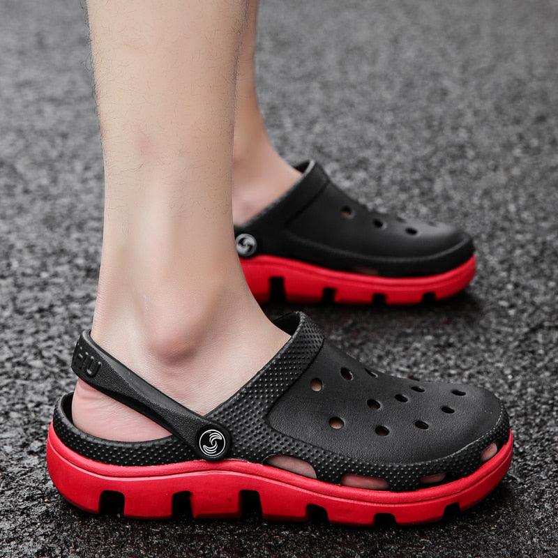Black men’s clogs with perforations, adjustable strap, and red/black chunky sole