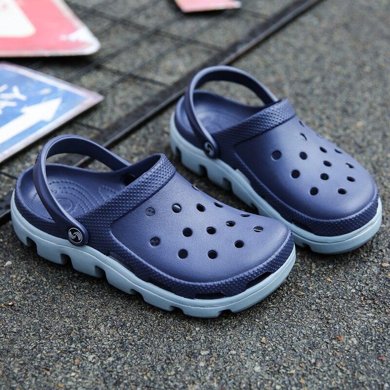 Men's navy perforated jelly clogs with adjustable strap and light blue outsole
