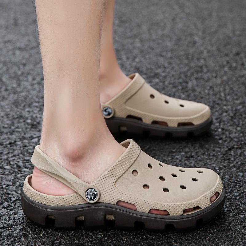 Beige perforated clogs with adjustable back strap and black chunky outsole