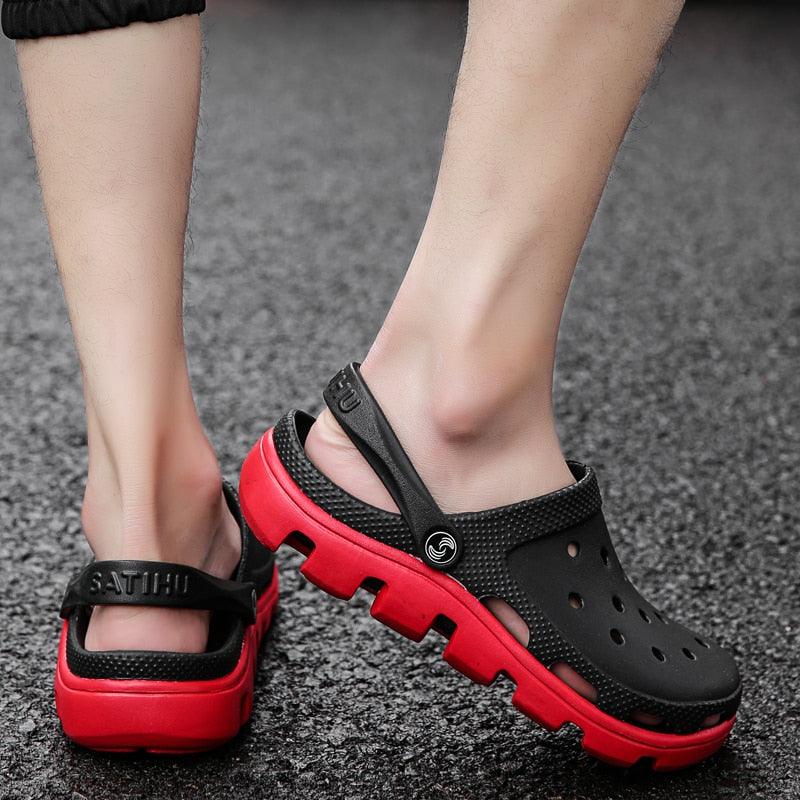 Men's black perforated jelly clogs with adjustable strap and red accents