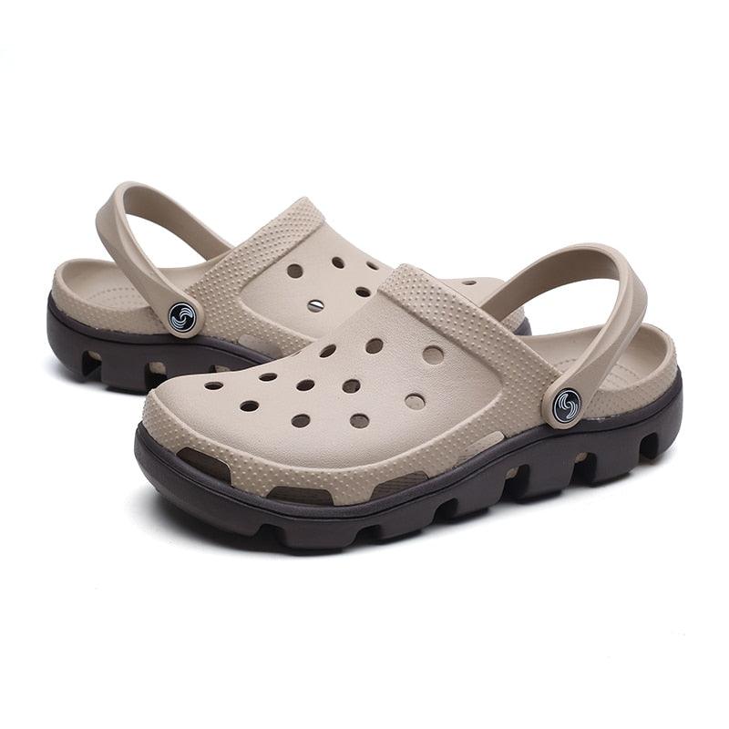 Beige men’s garden clogs with perforations, adjustable strap, and black rugged sole