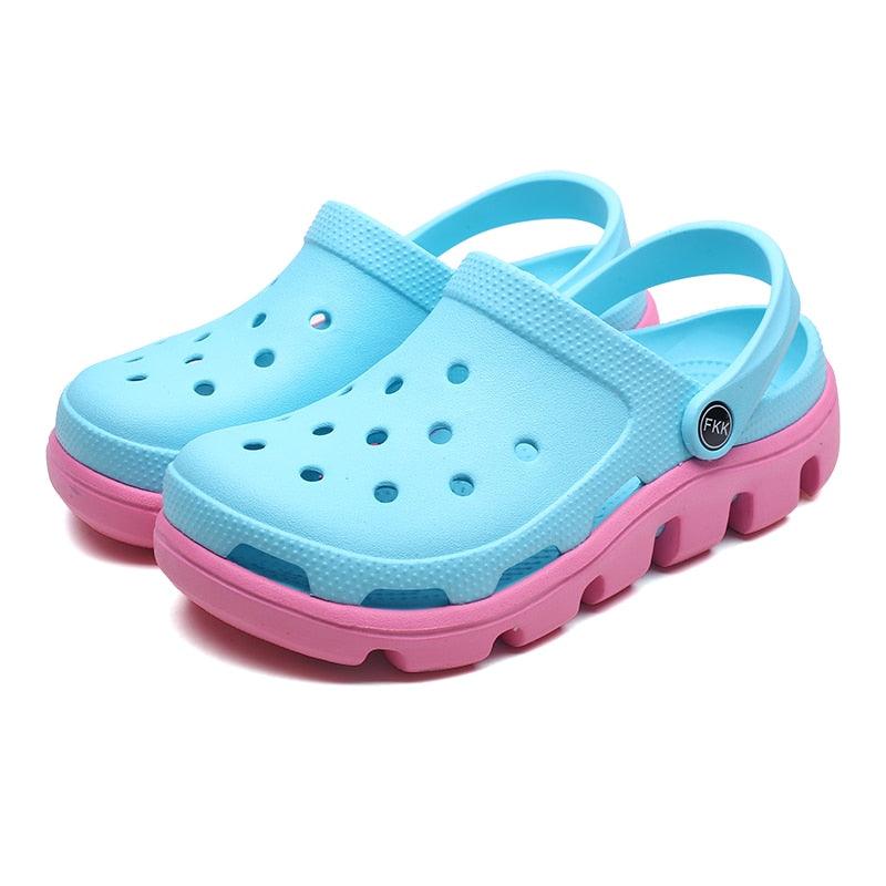 Light blue jelly clogs with perforated top, adjustable back strap, pink outer sole