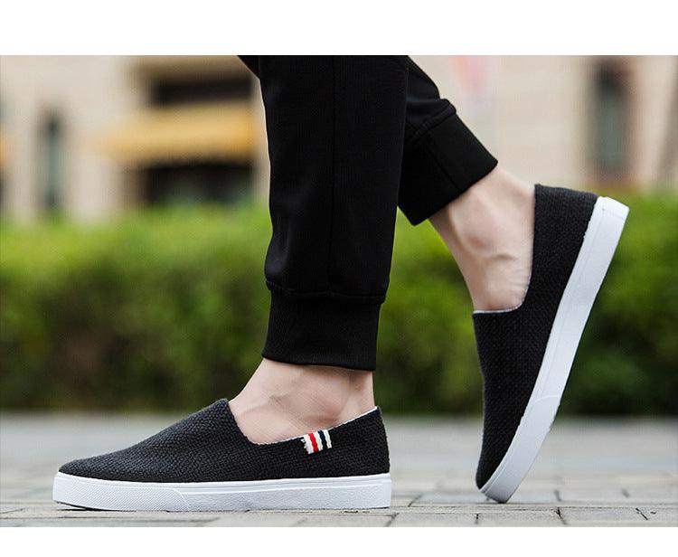 Black canvas slip-on sneakers with white rubber sole