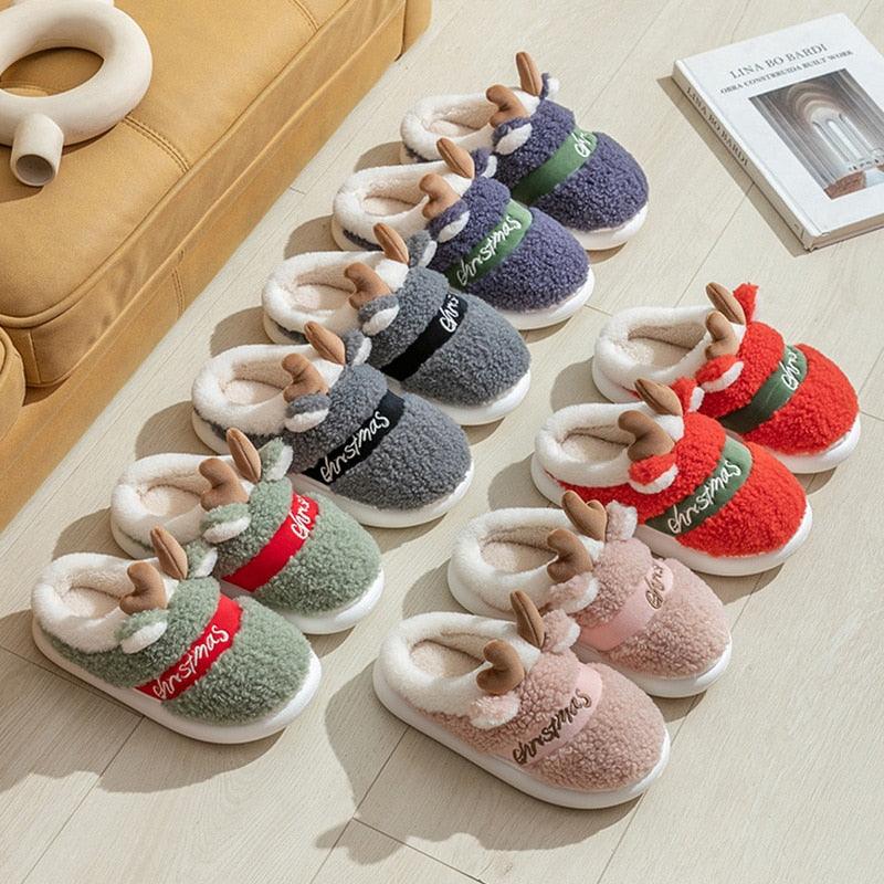 Kids plush deer Christmas slippers in mixed colors: gray, green, red, and pink.