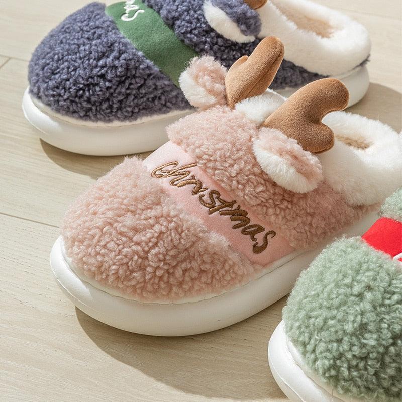 Set of fuzzy platform slippers in pink, dark gray, and green with deer antler decor