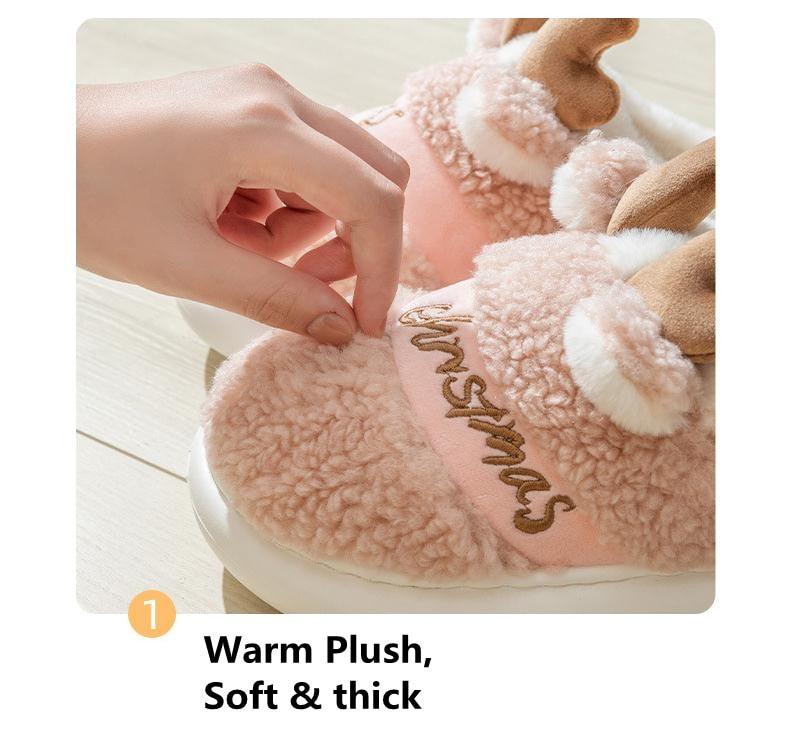 Pink plush deer slippers with antler applique and “Christmas” script on the toe