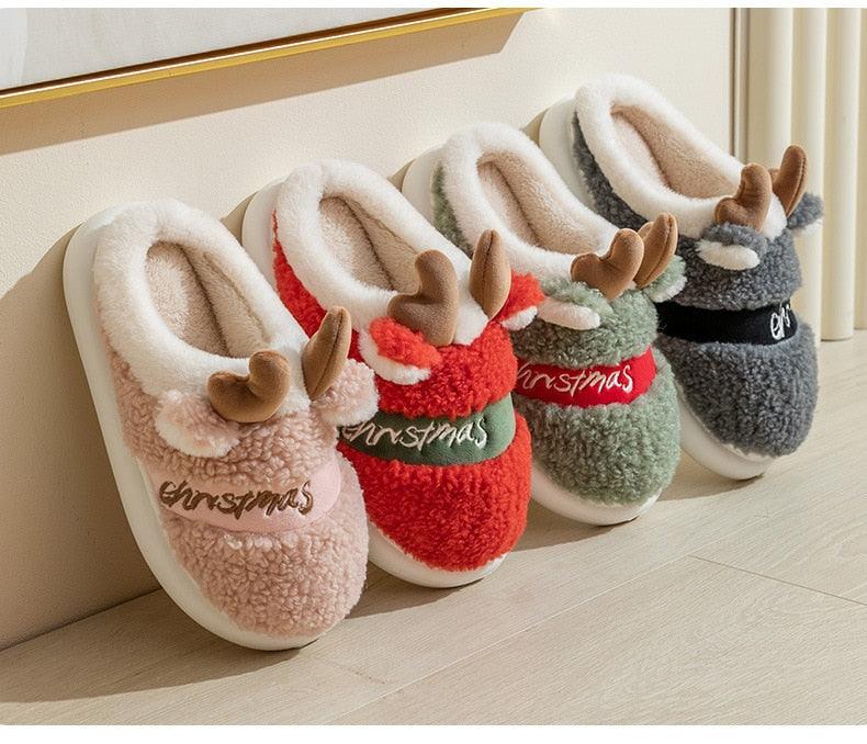 Mixed-color thick-soled plush deer Christmas slippers by the wall, with antler appliques.