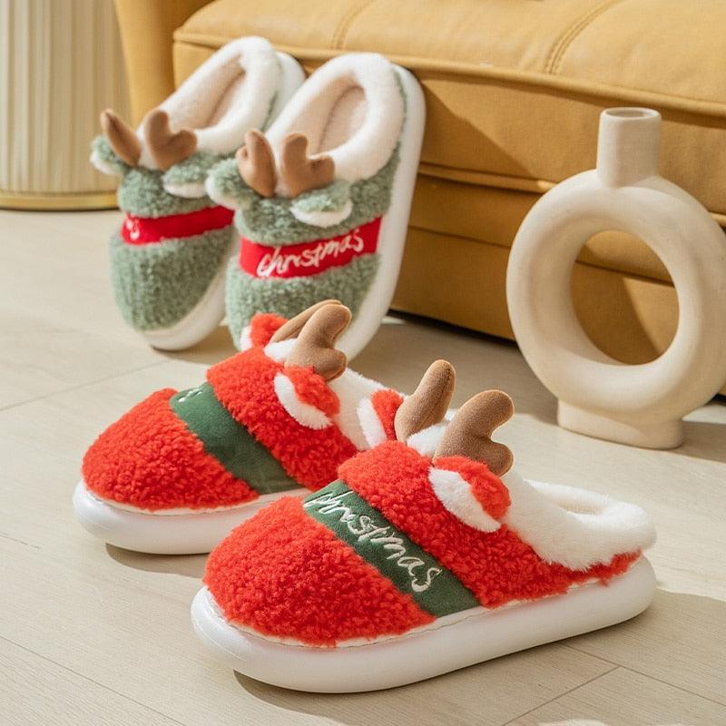 Thick-soled plush deer Christmas slippers, red and green with antler appliques.