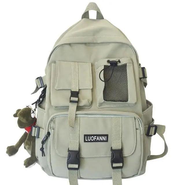 Light beige nylon backpack with front mesh pocket, flap panel, and adjustable straps