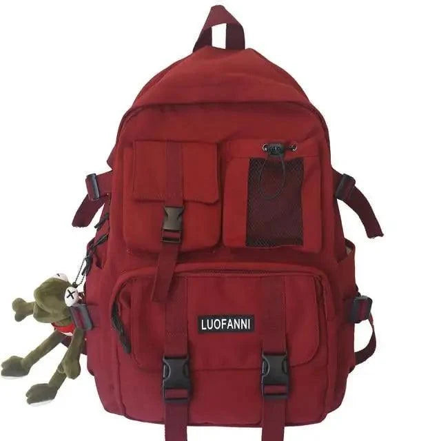 Red backpack with front flap pocket, mesh panel, and adjustable shoulder straps