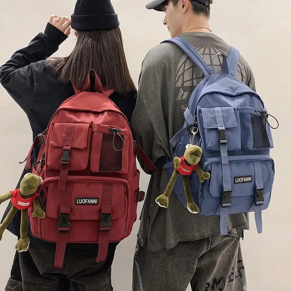 Red and blue nylon backpacks worn with front pockets, mesh panels, and straps