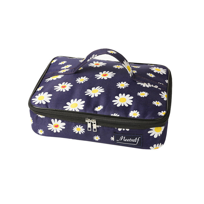 Navy daisy bento lunch bag with zip closure, top handle, and front logo label