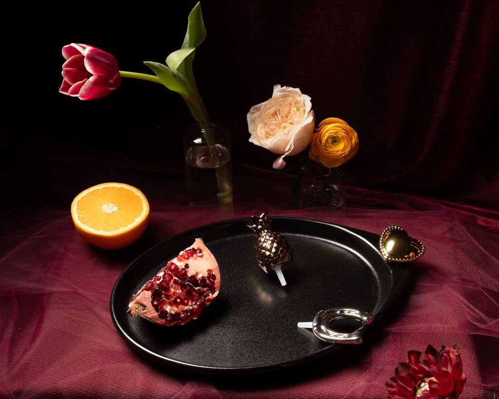Black oval tray with fruit and heart decorative pieces
