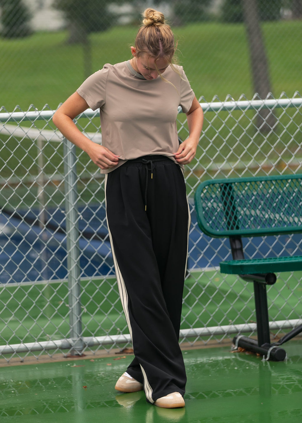 Black wide-leg track pants with white stripe detailing and drawstring waist