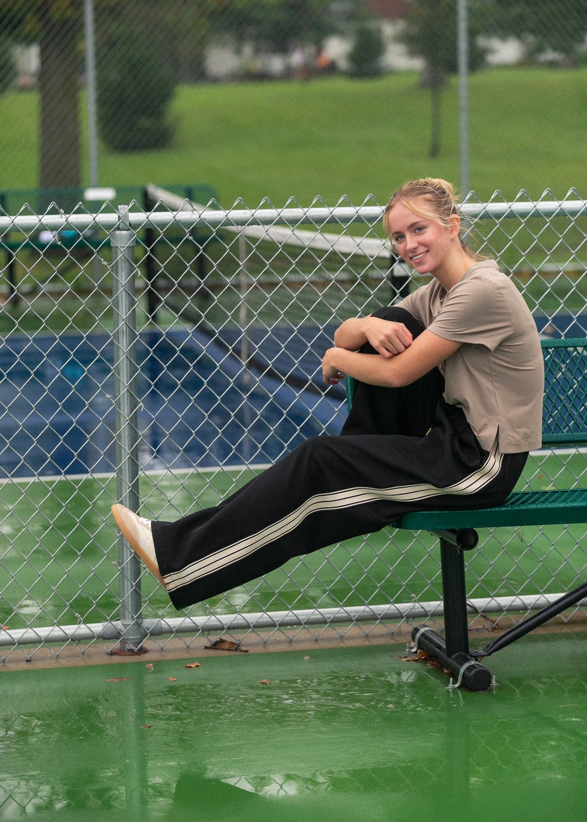 Black wide-leg track pants with white side stripes and draped relaxed legs