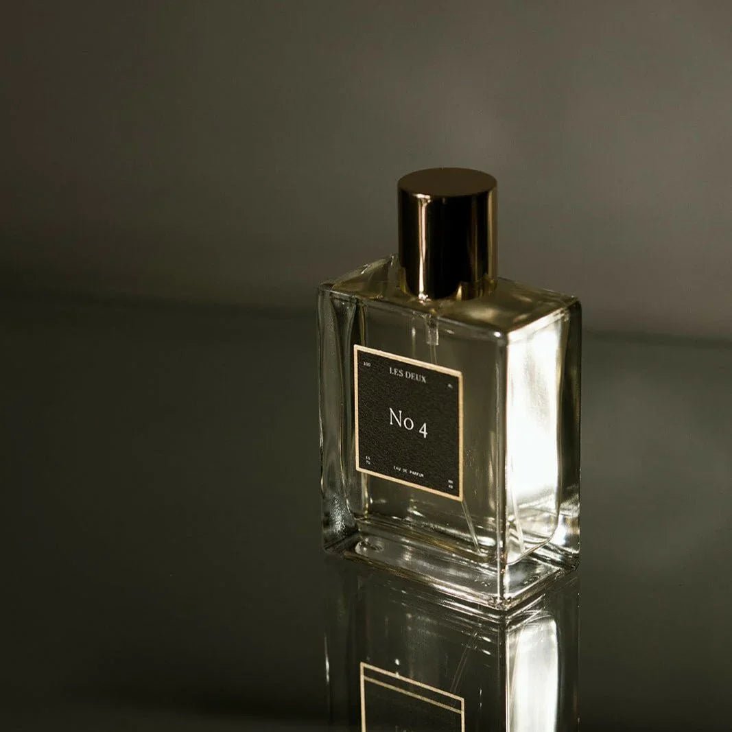 Glass perfume bottle with gold cap, No 4 label visible