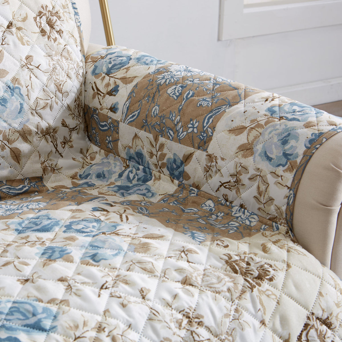 Reversible floral patchwork protector on chair seat and arm in cream and light blue
