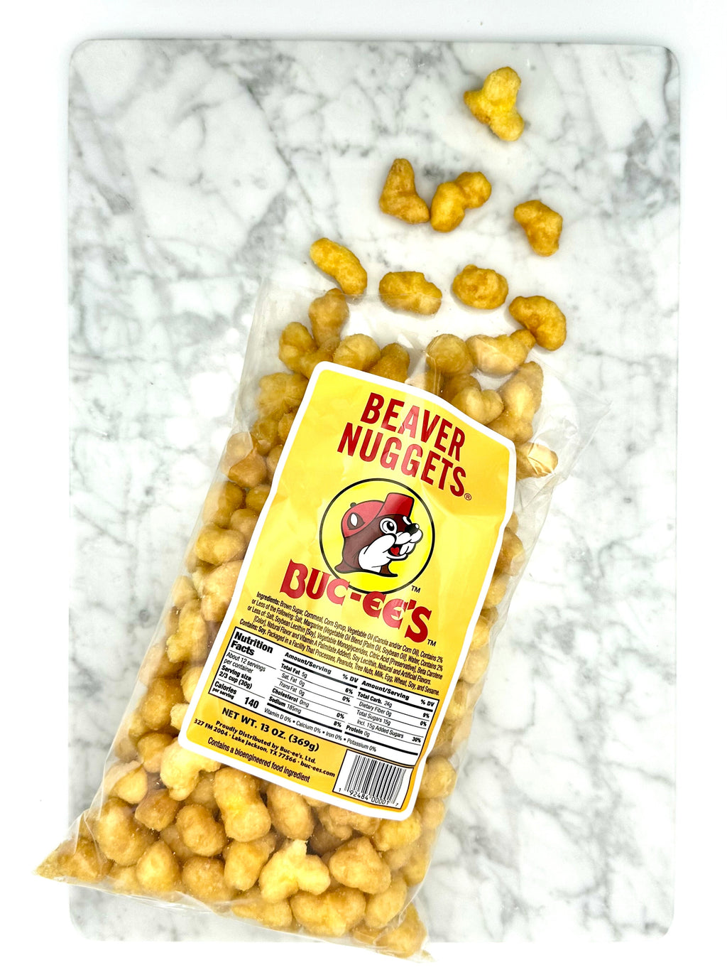 Beaver Nuggets snack bag with Buc-ee's branding, with scattered golden nugget pieces.