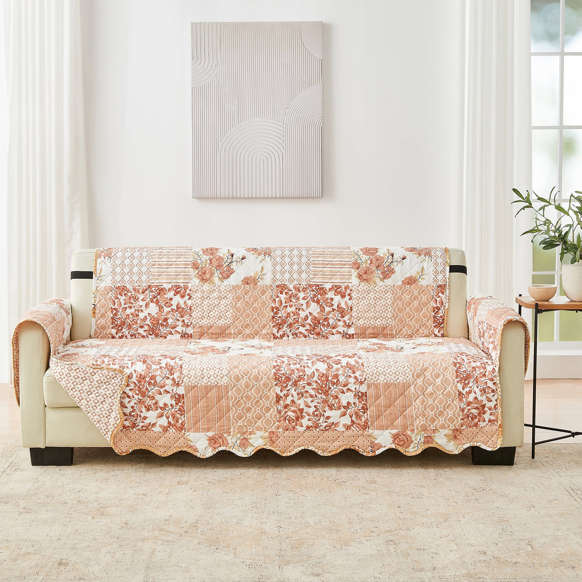 Reversible furniture protector with patchwork pattern in peach, rust, and beige tones