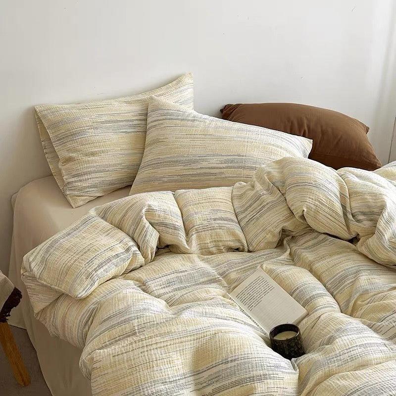Textured duvet cover set with cream stripe duvet cover and square pillow shams in beige tones