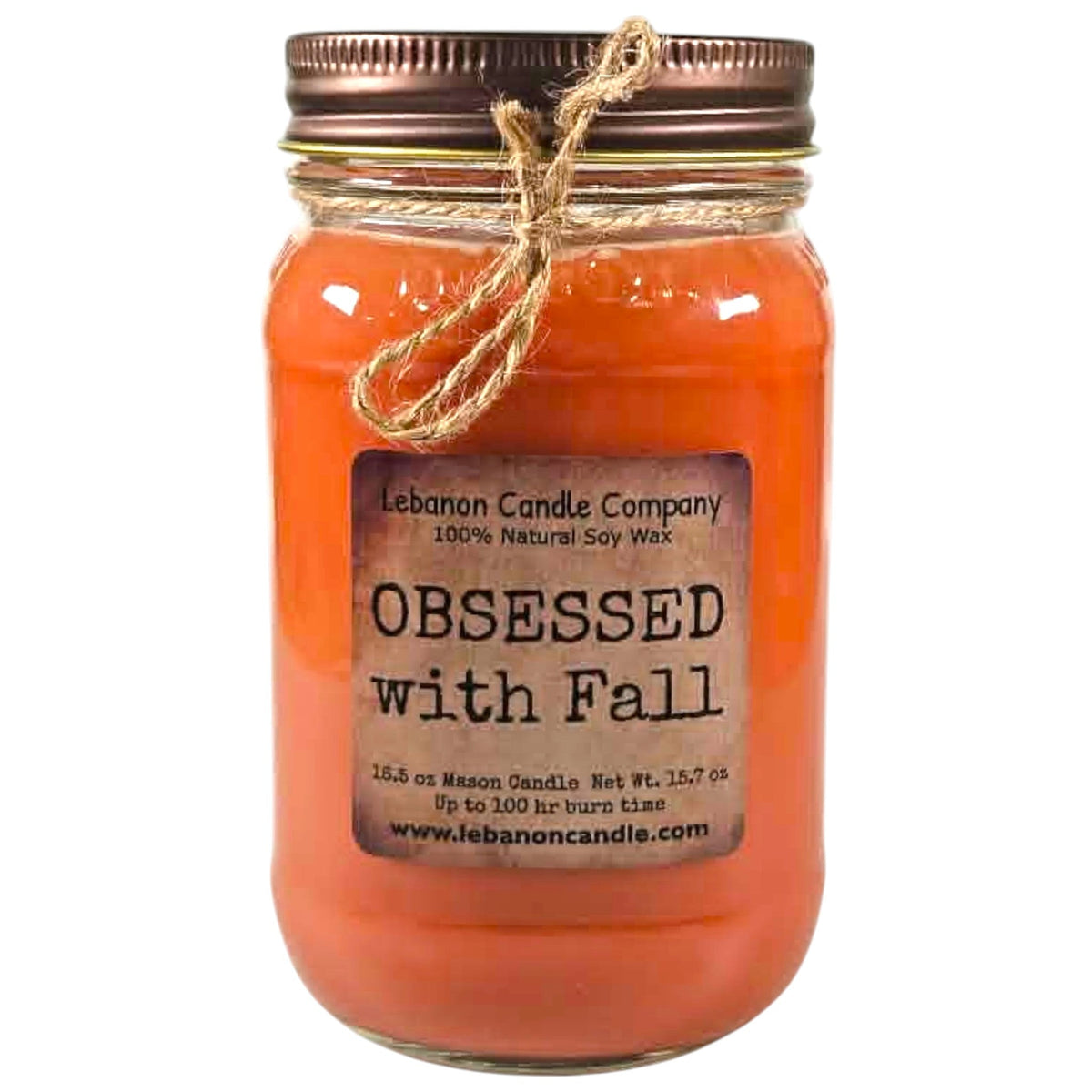 Orange jar candle with fabric-tied twine bow and printed label