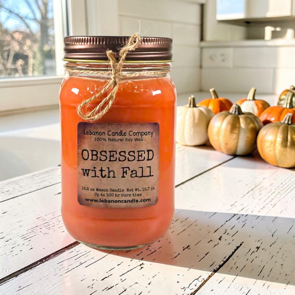 Orange jar candle with twine bow and label front on kitchen counter